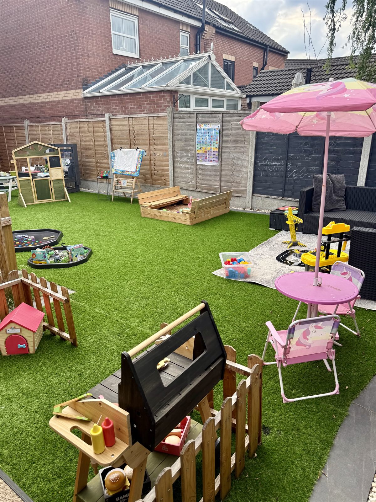 Our secure garden in Kirk Sandall with playhouse, mud kitchen, tuff trays and shaded seating