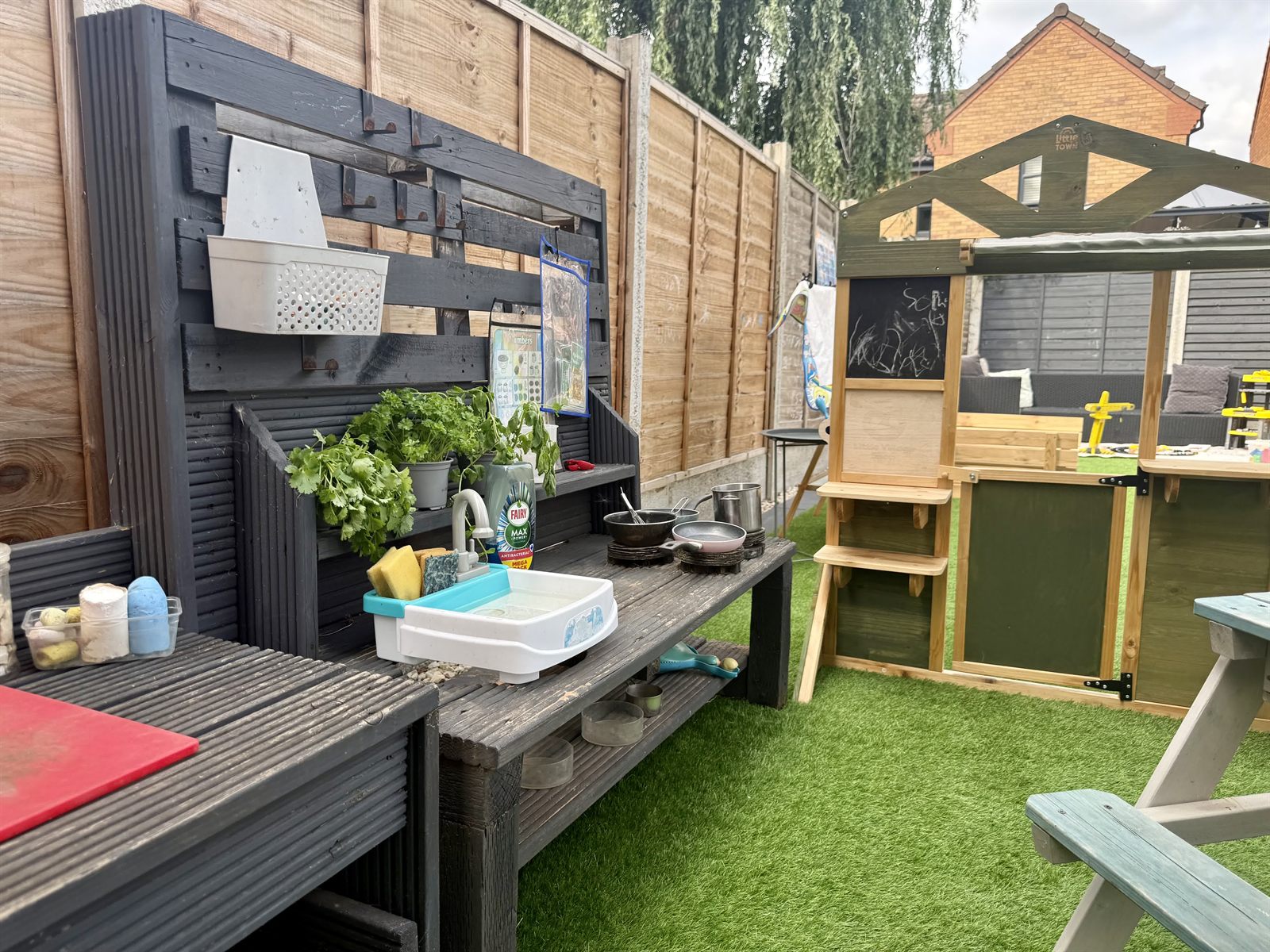 The mud kitchen with real pans, herbs and a growing station