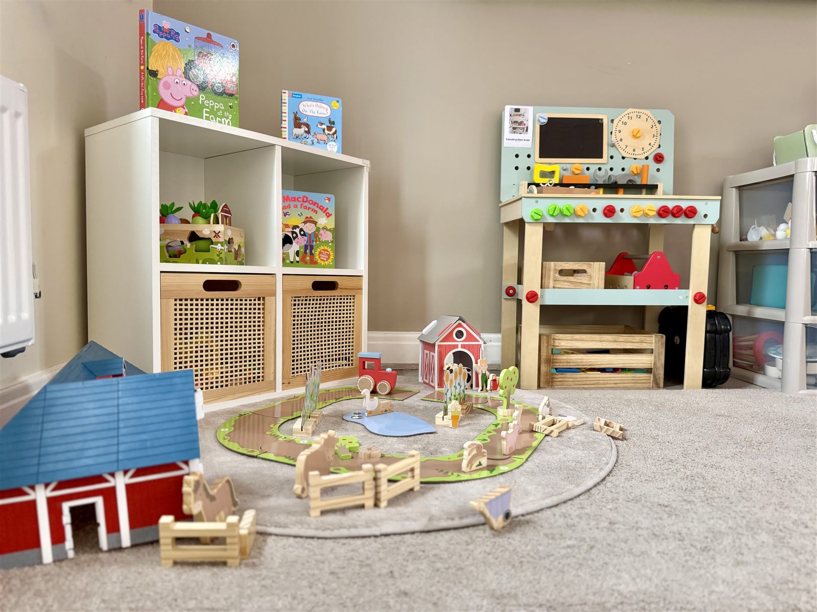 The small-world farm and construction area, with train track, animals and a workbench